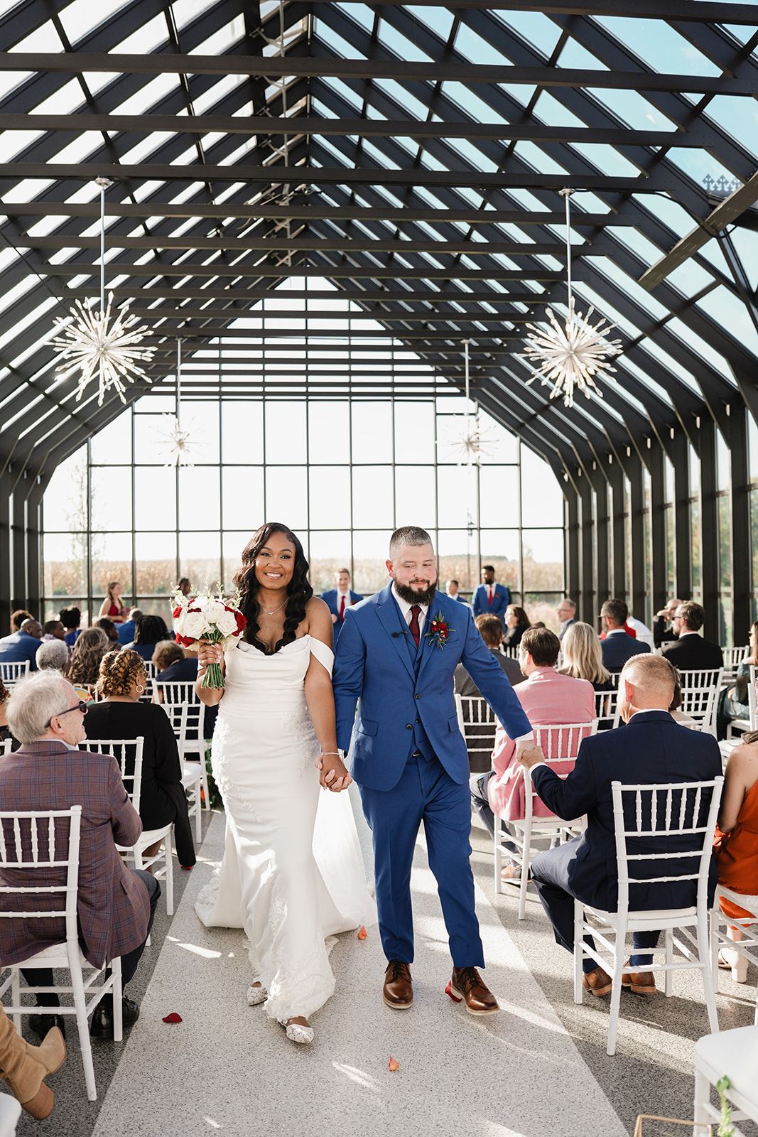 S and C walking down the aisle as married at Everhart Gathering Place