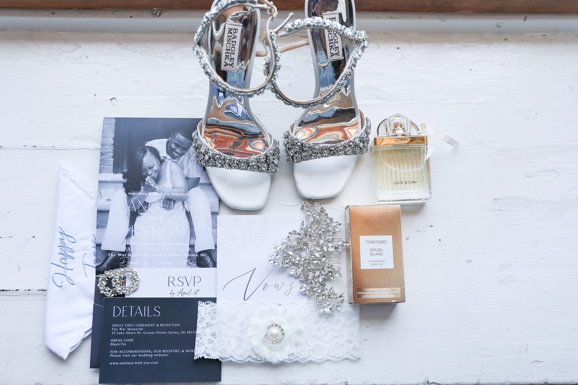 Bridal details flat lay: shoes, invitation suite, and fragrance at The War Memorial