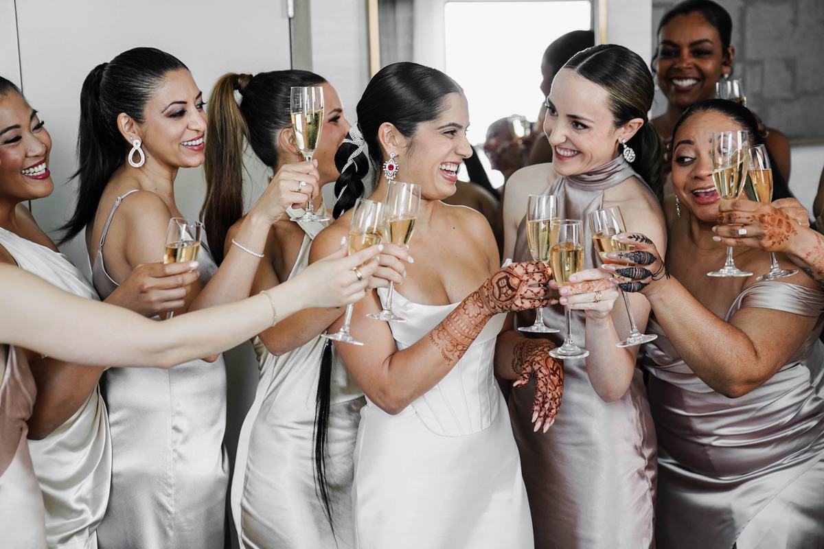 Bridal party champagne toast with henna detail, Detroit fusion wedding