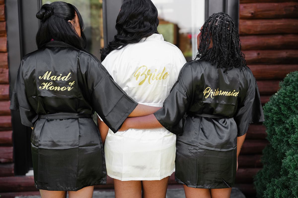 Bride and bridesmaids in personalized robes before the ceremony
