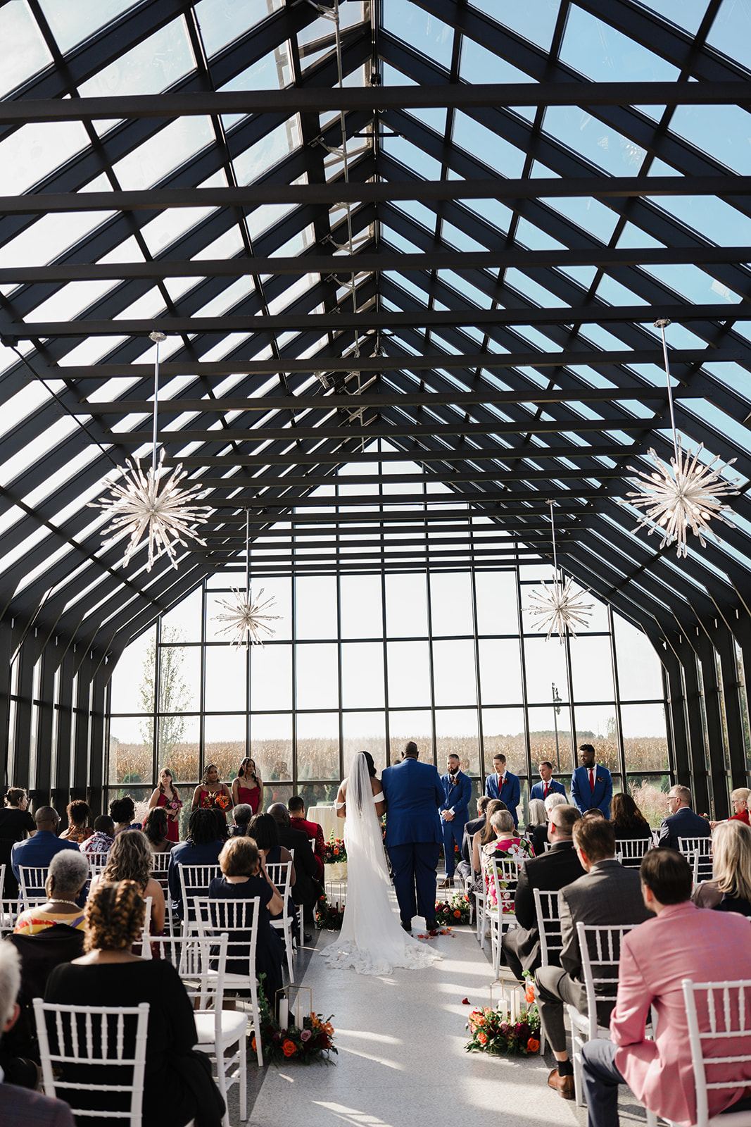 Wedding ceremony inside the glass chapel at Everhart Gathering Place, Nevada Ohio